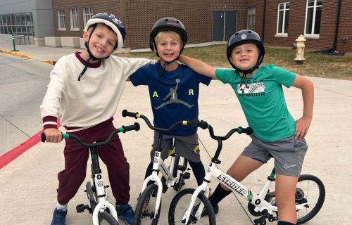 three boys on bicycles 